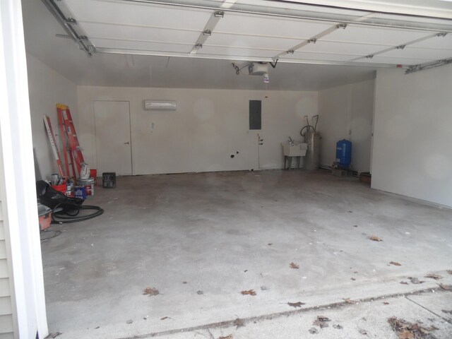 garage featuring electric panel, water heater, a garage door opener, and a sink