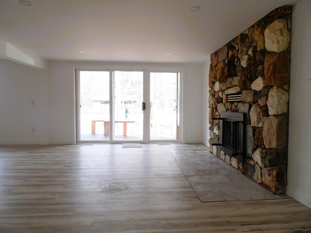 unfurnished living room with wood finished floors and a fireplace