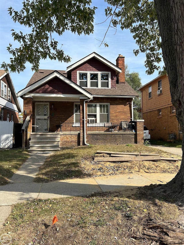 bungalow-style home with covered porch and a chimney