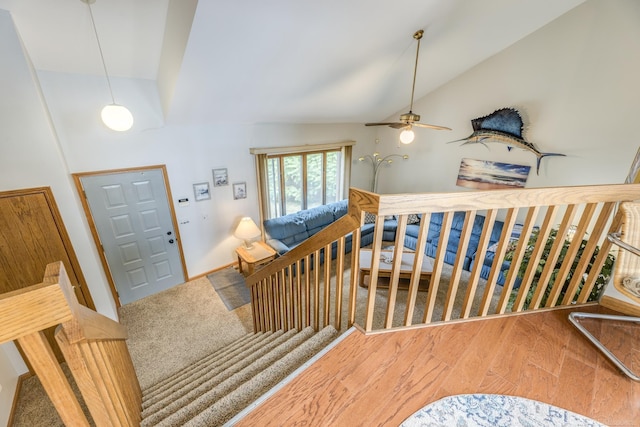 foyer with high vaulted ceiling, wood finished floors, and stairs