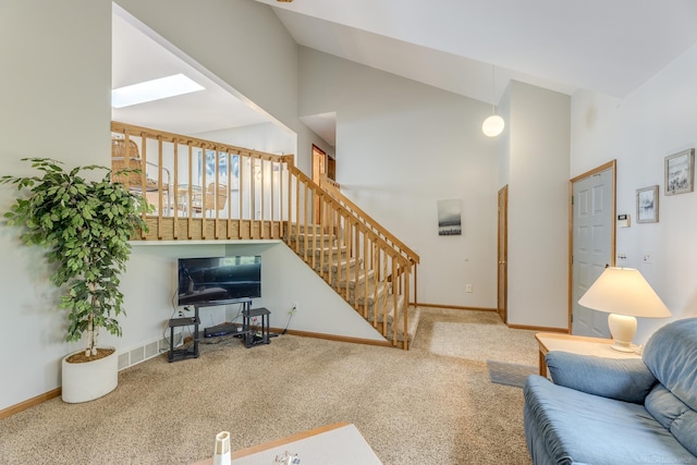 carpeted living area with stairway, baseboards, high vaulted ceiling, and visible vents