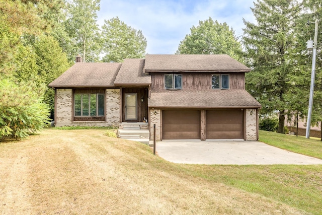 tri-level home with a shingled roof, concrete driveway, an attached garage, a front yard, and brick siding