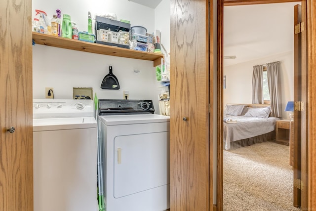 laundry room with laundry area, independent washer and dryer, and carpet flooring