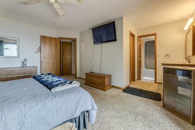 bedroom with a ceiling fan, wine cooler, carpet, and baseboards