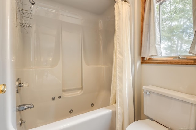 full bathroom featuring shower / tub combo with curtain and toilet