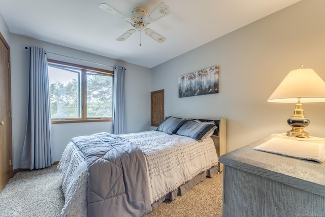 bedroom with a ceiling fan and light colored carpet