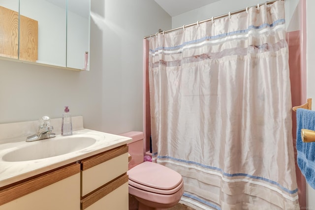 bathroom with a shower with shower curtain, toilet, and vanity