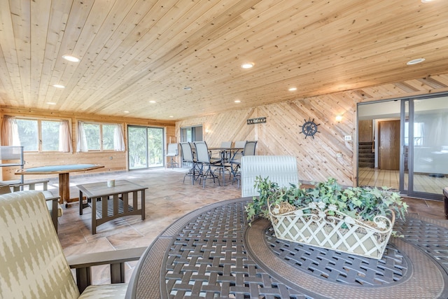 dining space featuring recessed lighting, wooden walls, and wooden ceiling