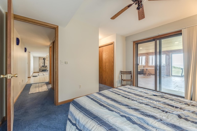 carpeted bedroom featuring a closet, baseboards, a ceiling fan, and access to outside