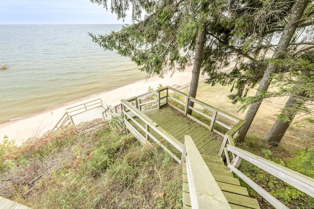 drone / aerial view with a beach view and a water view