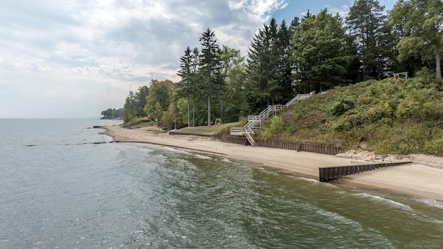 view of water feature featuring stairs and a view of the beach