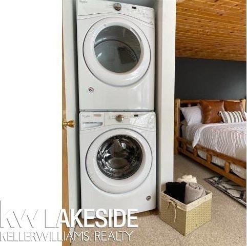 clothes washing area with wood ceiling, laundry area, and stacked washing maching and dryer