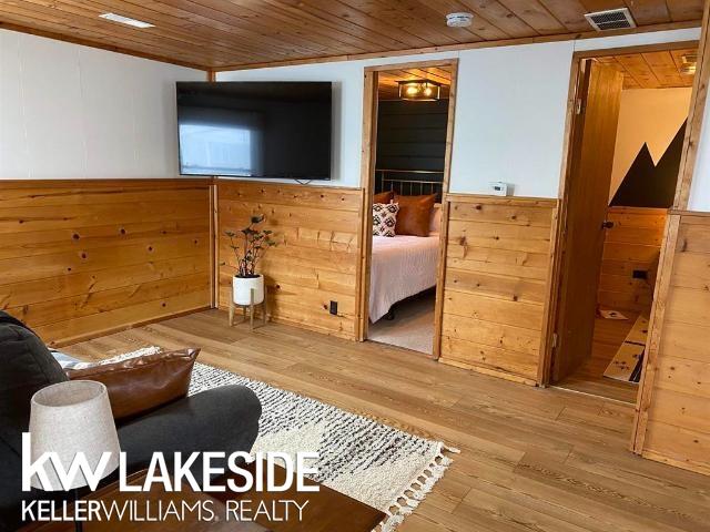 interior space featuring visible vents, wood walls, wood ceiling, and wood finished floors