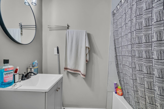 bathroom featuring vanity and shower / bathtub combination with curtain