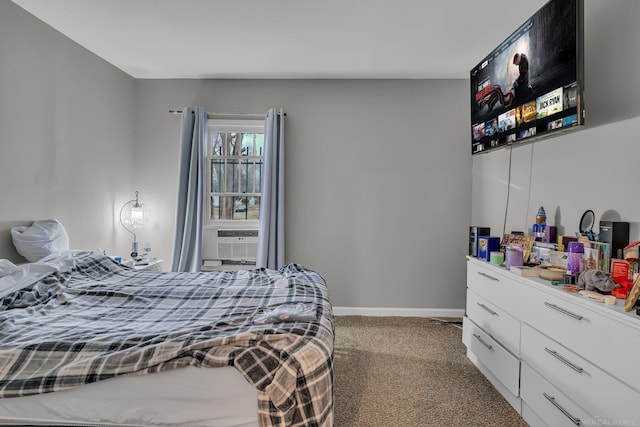 bedroom with cooling unit, baseboards, and carpet flooring