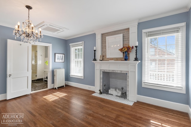 unfurnished living room featuring radiator, crown molding, baseboards, a fireplace, and wood finished floors