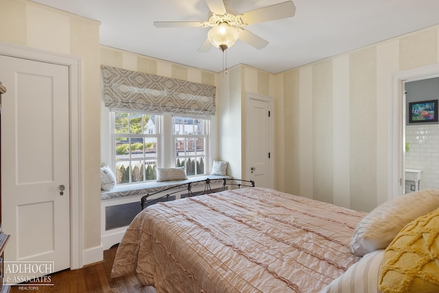 bedroom featuring wallpapered walls, a ceiling fan, and dark wood-style flooring