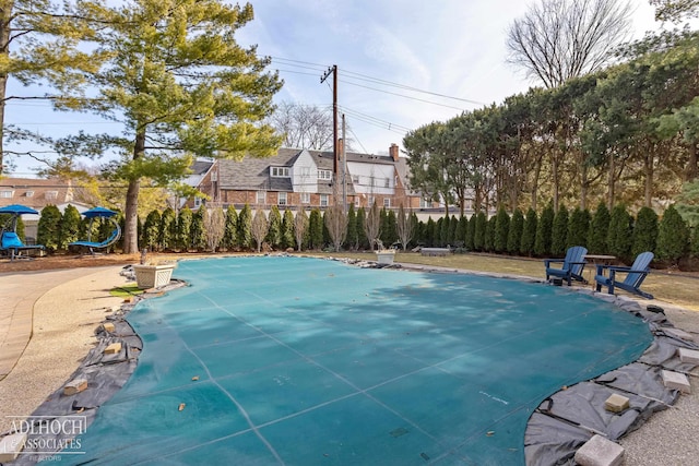 view of swimming pool featuring fence