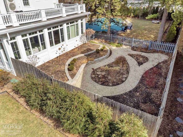 view of yard with a balcony and a fenced backyard