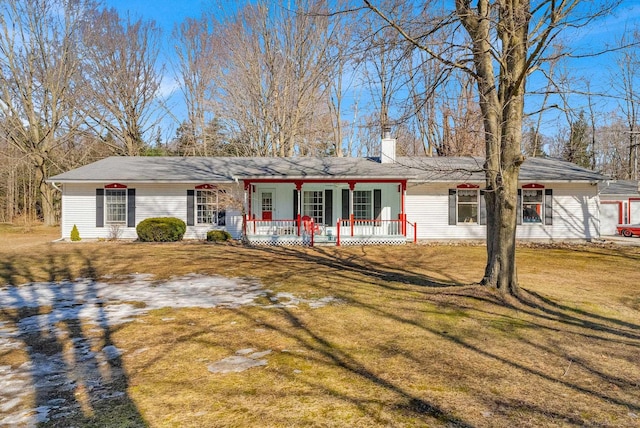 ranch-style house featuring a porch, a front yard, and a chimney