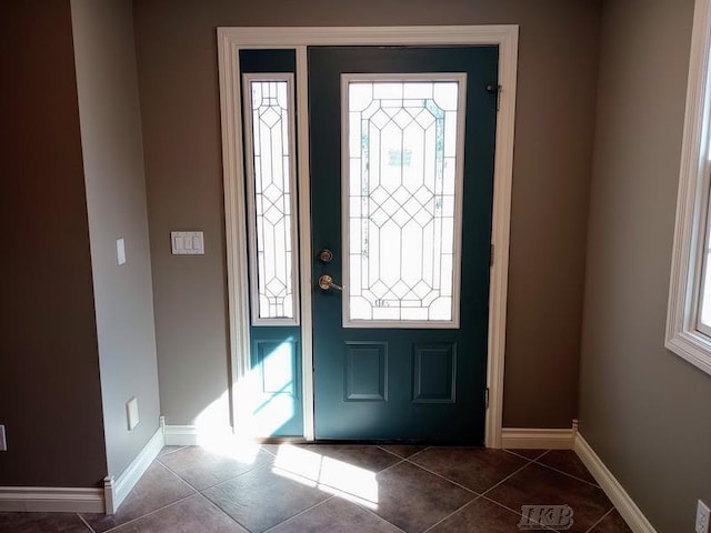 foyer featuring tile patterned flooring and baseboards