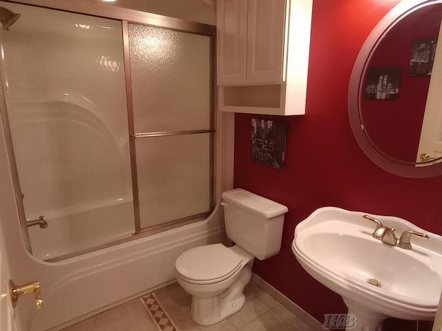 full bathroom with tile patterned floors, toilet, baseboards, and a sink