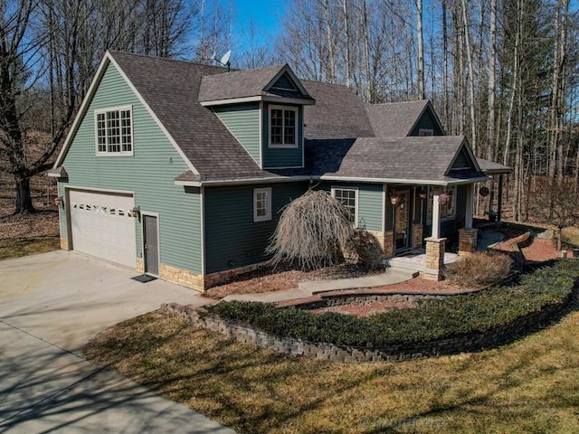 view of front facade featuring a garage, concrete driveway, and roof with shingles