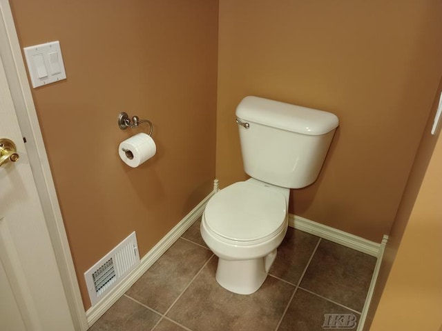 bathroom featuring visible vents, baseboards, toilet, and tile patterned flooring