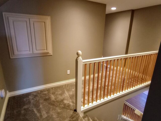 corridor with recessed lighting, baseboards, carpet, and an upstairs landing