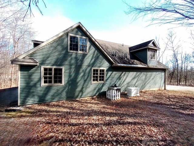 back of house featuring central AC