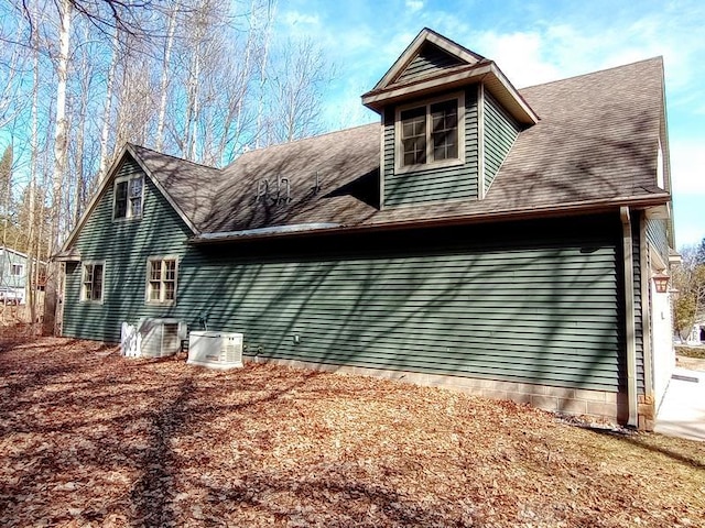 back of house with central AC