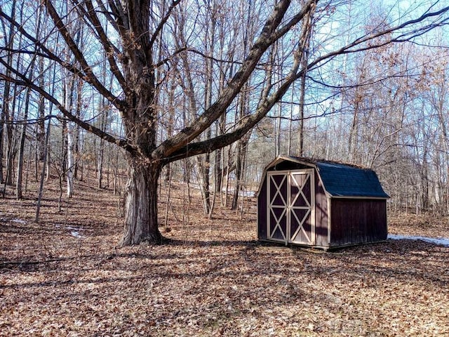 view of shed with a forest view