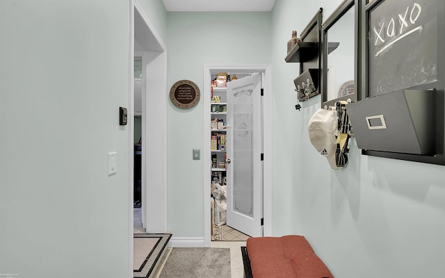 hall with tile patterned flooring