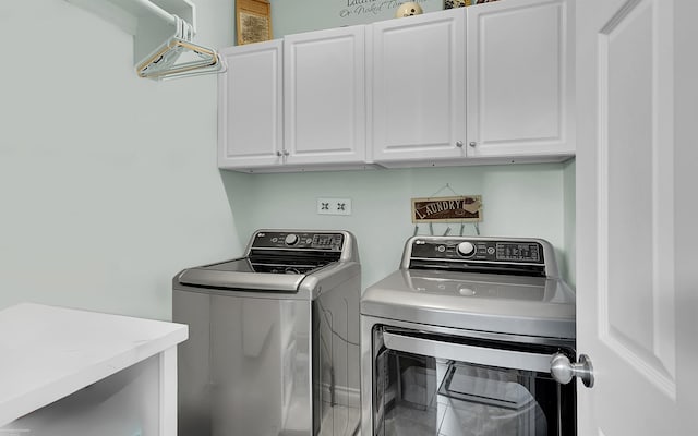 laundry room featuring cabinet space and separate washer and dryer