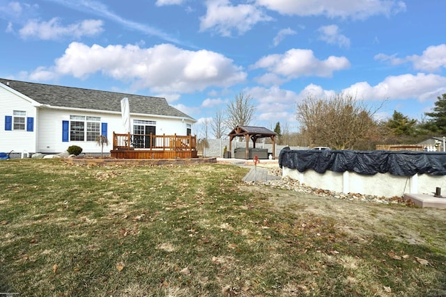 view of yard featuring a gazebo, a deck, and a covered pool