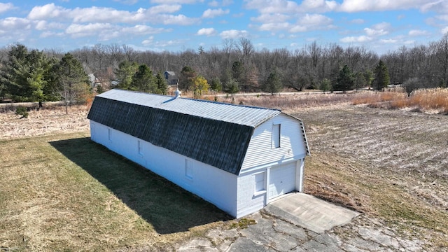 view of outbuilding featuring an outbuilding and a forest view