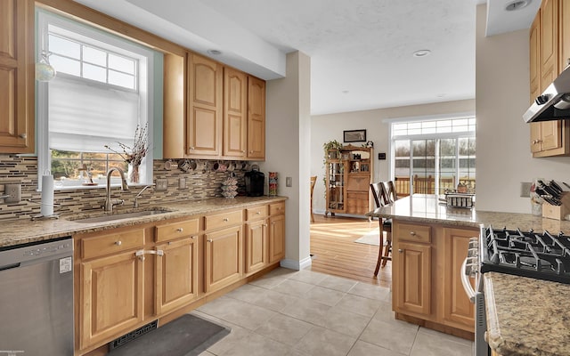 kitchen featuring light tile patterned floors, visible vents, a sink, stainless steel appliances, and under cabinet range hood