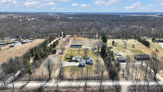 drone / aerial view featuring a rural view and a wooded view