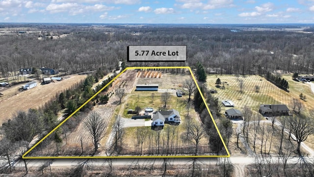 birds eye view of property with a view of trees