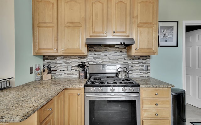 kitchen featuring under cabinet range hood, decorative backsplash, gas stove, and light brown cabinetry