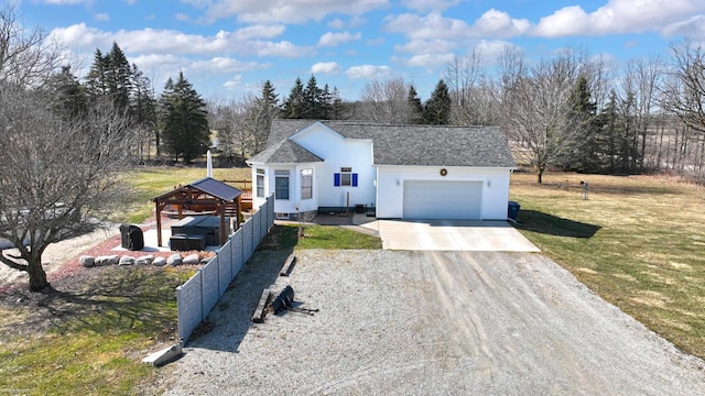 view of front facade with a garage, a front lawn, driveway, and a shingled roof