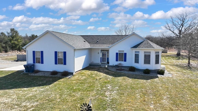 ranch-style home featuring a front lawn and a shingled roof