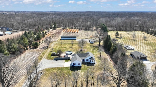 birds eye view of property with a forest view and a rural view