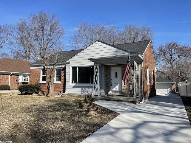 view of front facade with brick siding and an outdoor structure