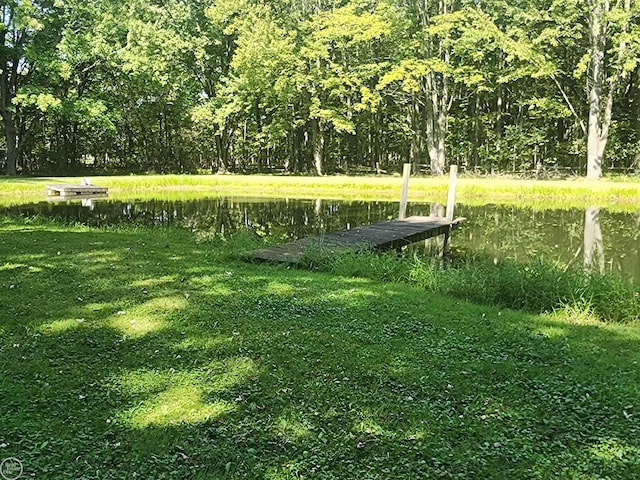 view of community with a lawn and a water view