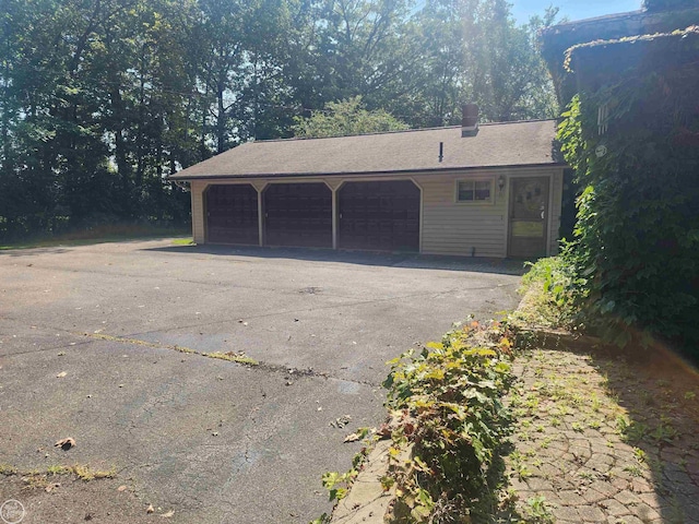 garage with aphalt driveway