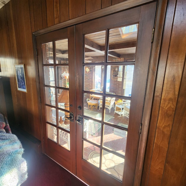 doorway to outside featuring french doors and wood walls