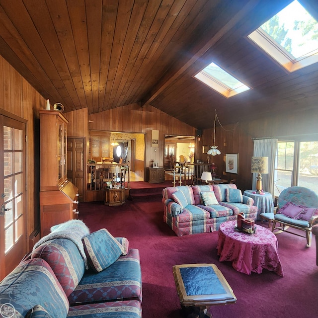 carpeted living room with vaulted ceiling with skylight, wood ceiling, and wood walls