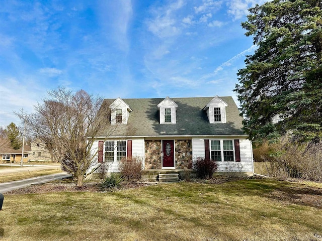 new england style home featuring a front yard