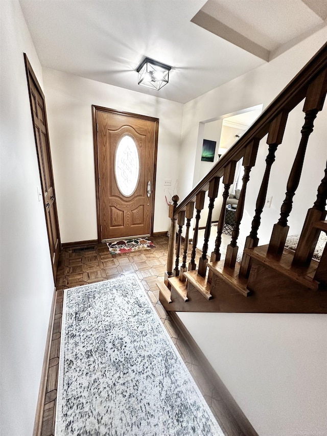 entryway with stairs and baseboards